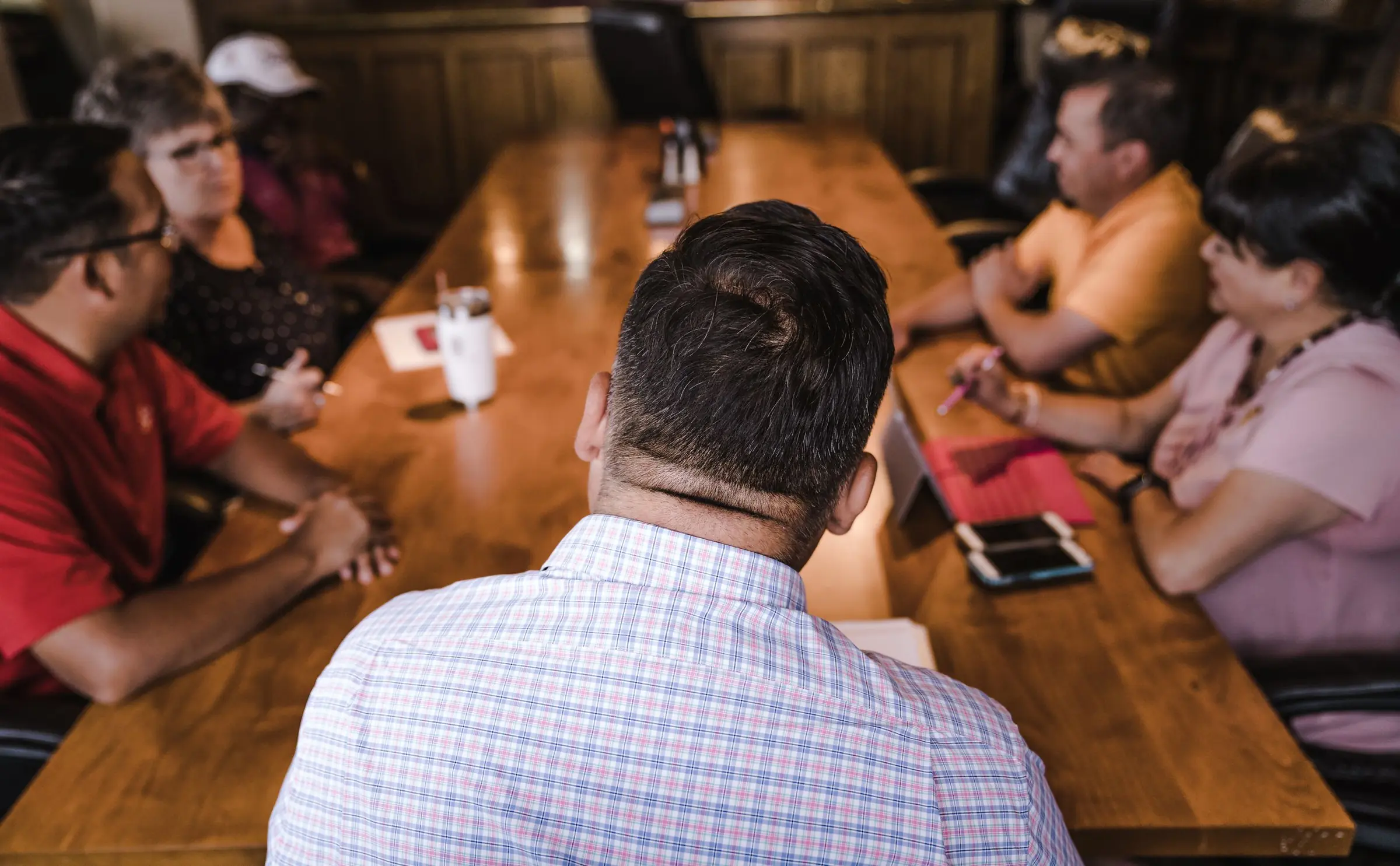 Meeting around a large wooden table